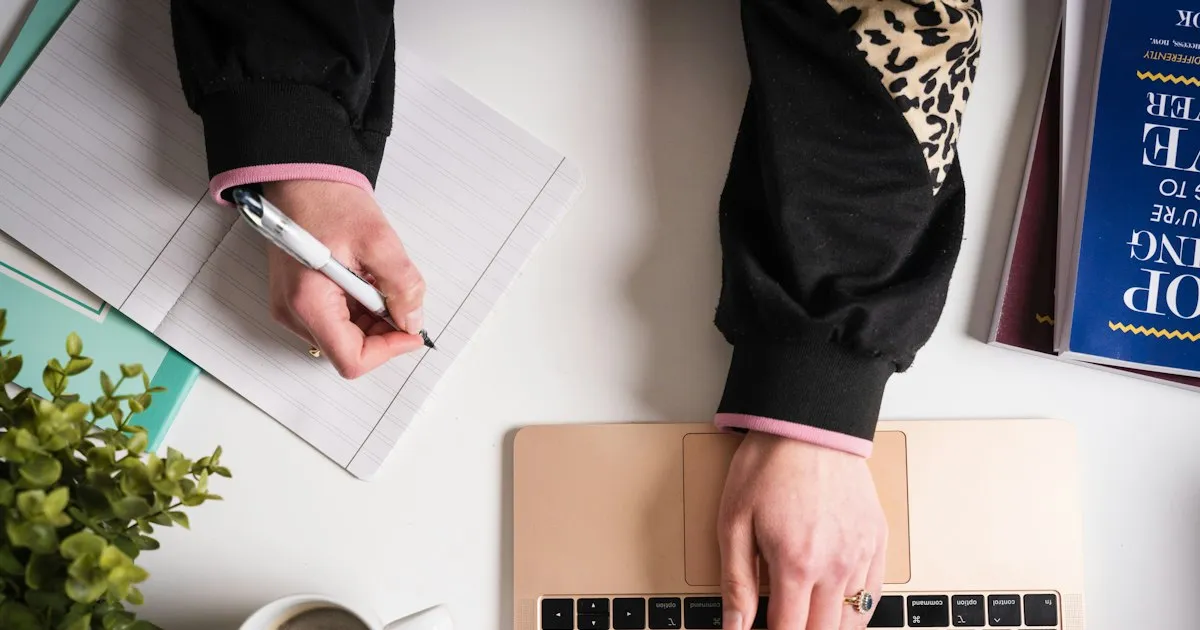A person writing by hand in a notebook at a desk. Photo by Jodie Cook on Unsplash.