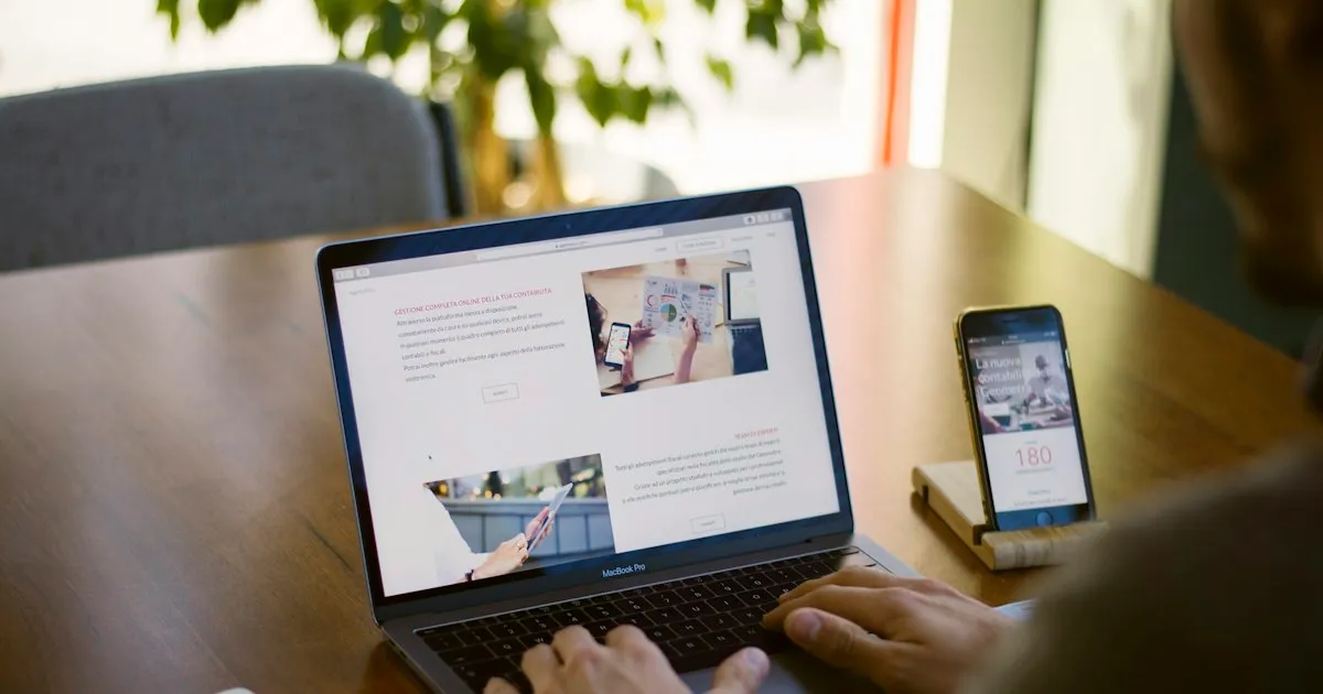 A laptop and a phone on a desk, both showing a website. Photo by Agefis on Unsplash.
