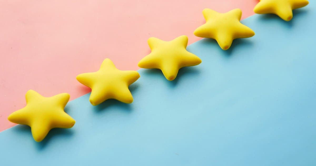 A row of yellow stars sitting on top of a blue and pink surface